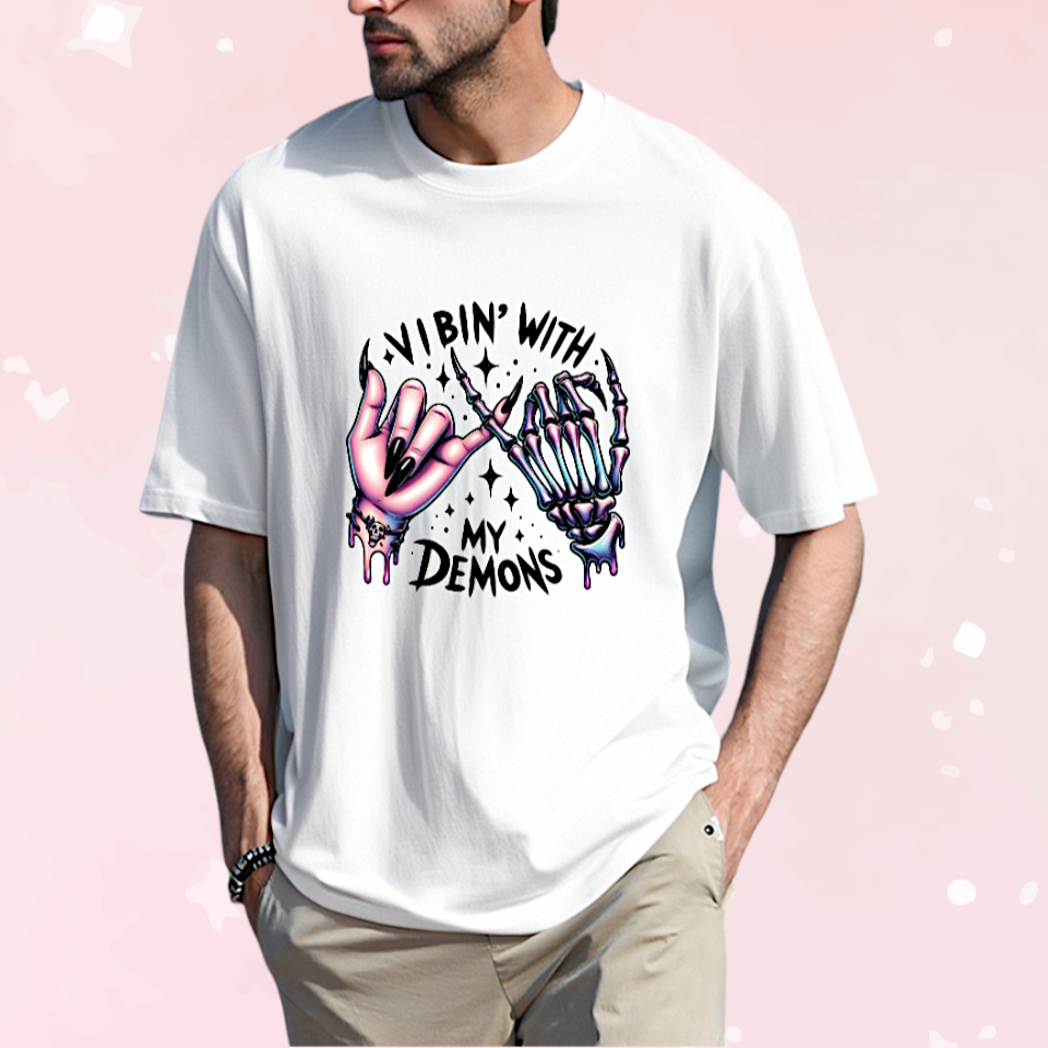 Man wearing a white t-shirt with a graphic design and text on a pink background