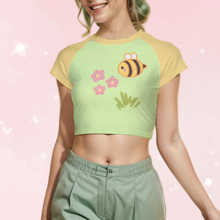 Woman wearing a green and yellow crop top with a bee design on a pink background