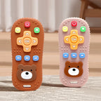 Two toy remote controls with bear faces on a neutral background