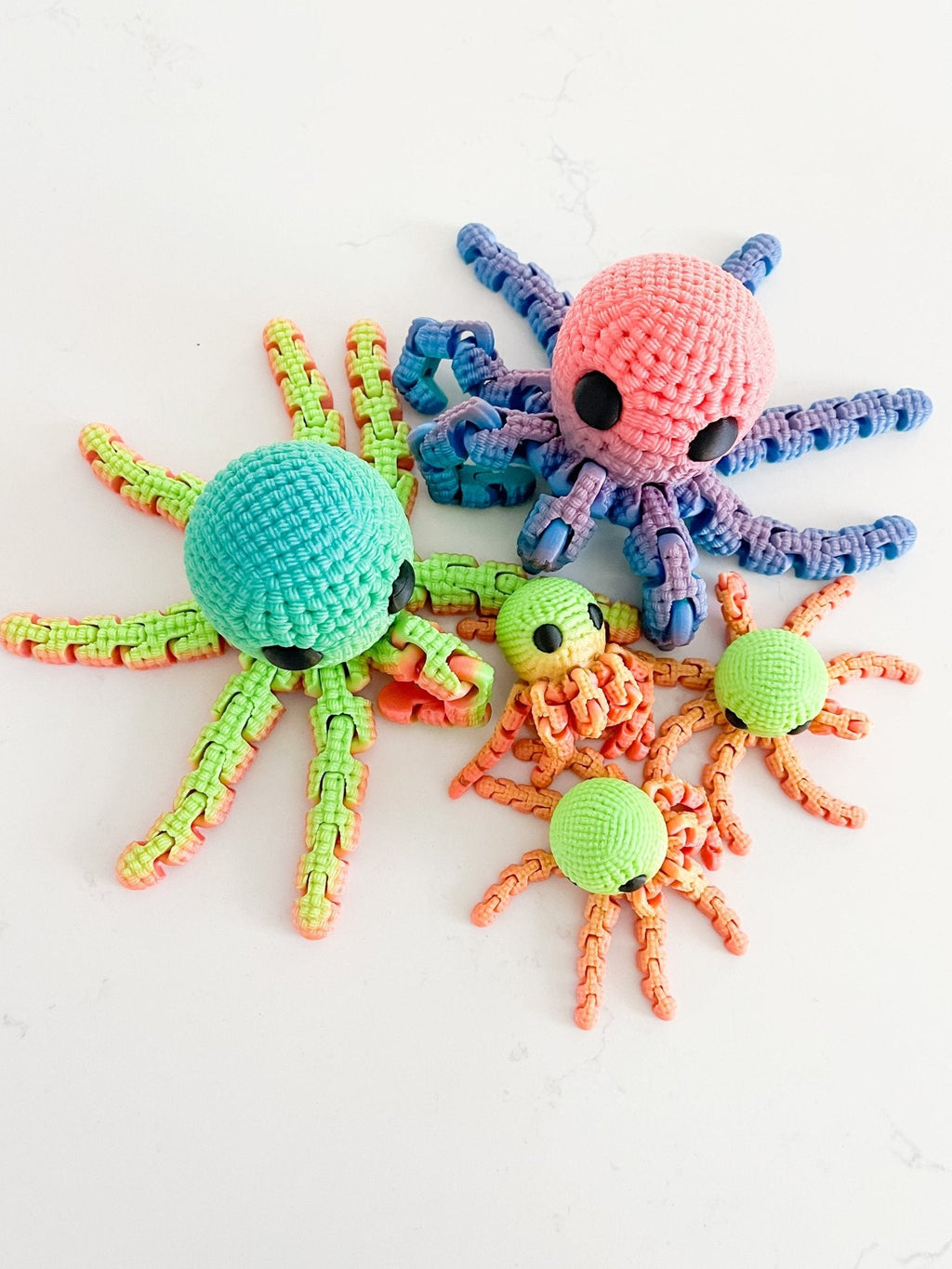 Colorful crochet octopus toys on a white background