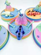 Colorful sand toys with animals and sandcastles on a white background